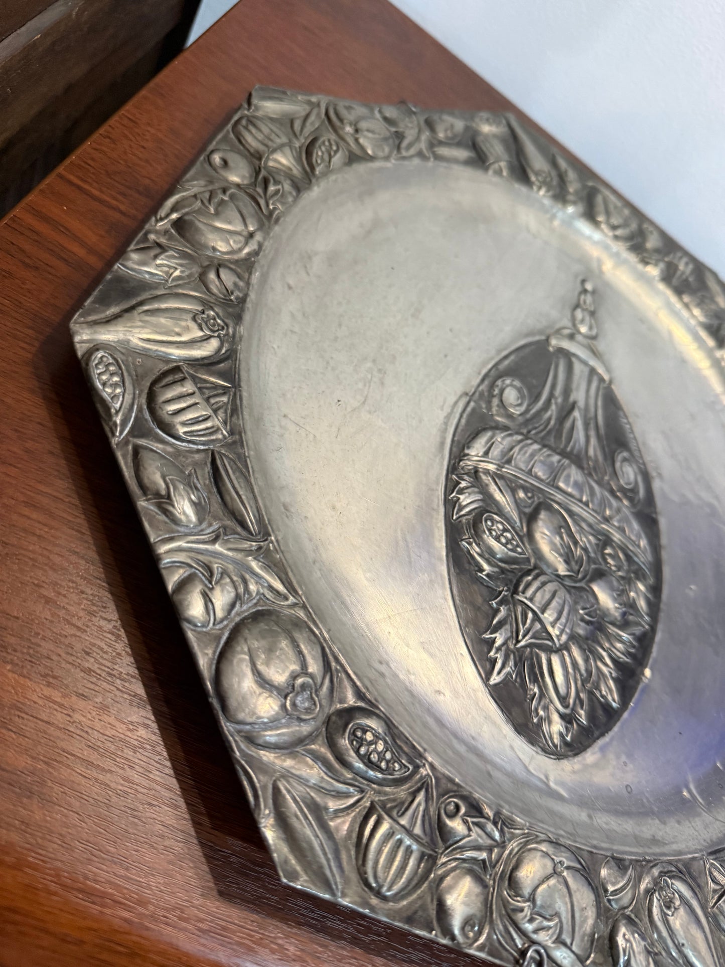 Grande assiette murale en métal repoussé signée Coquerelle – décor corbeille de fruits